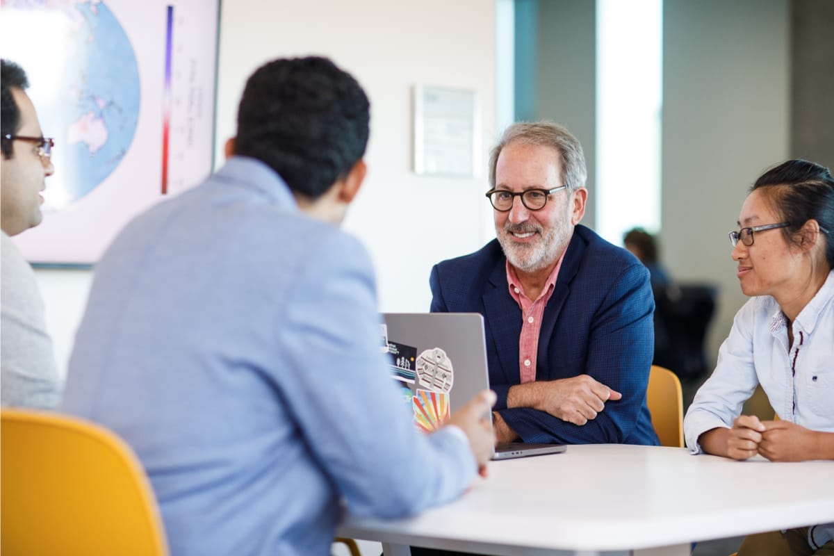 ASU College of Global Futures faculty members engaging with students in a professional setting